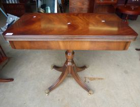 20TH CENTURY MAHOGANY PEDESTAL FLIP-TOP GAMES TABLE ON 3 SPREADING BALL & CLAW SUPPORTS