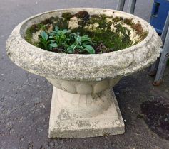 RECONSTITUTED STONE GARDEN URN ON PLINTH BASE.