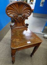 19TH CENTURY OAK HALL CHAIR WITH CARVED SHELL BACK ON TURNED SUPPORTS.