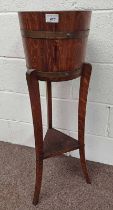 OAK BARREL PLANTER WITH BRASS BANDING ON STAND WITH 3 SPLAYED SUPPORTS. HEIGHT 90.