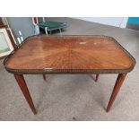 20TH CENTURY MAHOGANY TRAY TABLE WITH DECORATIVE BRASS GALLERY ON REEDED SUPPORTS.