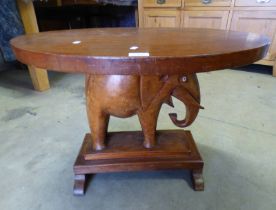 MAHOGANY OVAL TOPPED TABLE ON CARVED CENTRE PEDESTAL MODELLED AFTER AN ELEPHANT,