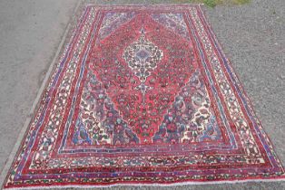 TERRACOTTA GROUND PERSIAN / VILLAGE CARPET WITH CENTRAL MEDALLION DESIGN 305 X 210CM