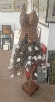WICKER BOUND CORSET WITH TREE BRANCH SKIRT ON STAND,