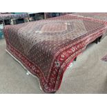 RED GROUND MIDDLE EASTERN CARPET WITH GEOMETRIC DESIGN 305CM X 200CM