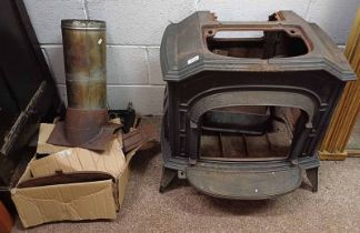 CAST IRON WOOD BURNING STOVE WITH VARIOUS FIXTURES