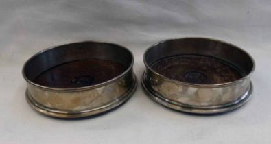 PAIR OF SILVER WINE SLIDES ON MAHOGANY BASES,