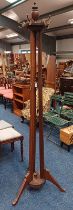 MAHOGANY HAT TREE WITH ROTATING TOP ON 3 SPREADING REEDED SUPPORTS.