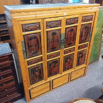 EASTERN PINE CABINET WITH 4 PANEL DOORS WITH RED & BLACK LACQUER ORIENTAL DECORATION OPENING TO 3