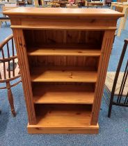 PINE OPEN BOOKCASE ON PLINTH BASE.