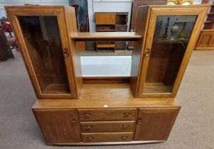 ERCOL ELM LIVING ROOM UNIT WITH 2 GLAZED PANEL DOORS OPENING TO SHELVED INTERIOR OVER BASE WITH 3