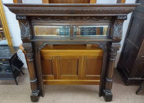 CARVED OAK FIRE SURROUND WITH MIRROR PANEL INSET & DECORATIVE CORINTHIAN COLUMNS.