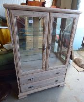 LIMED OAK EFFECT DISPLAY CABINET WITH 2 GLAZED PANEL DOORS OPENING TO GLASS SHELVED INTERIOR OVER 2
