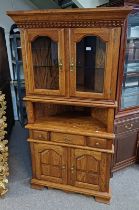 OAK CORNER CABINET WITH 2 GLAZED PANEL DOORS OVER BASE WITH SINGLE DRAWER & 2 PANEL DOORS,