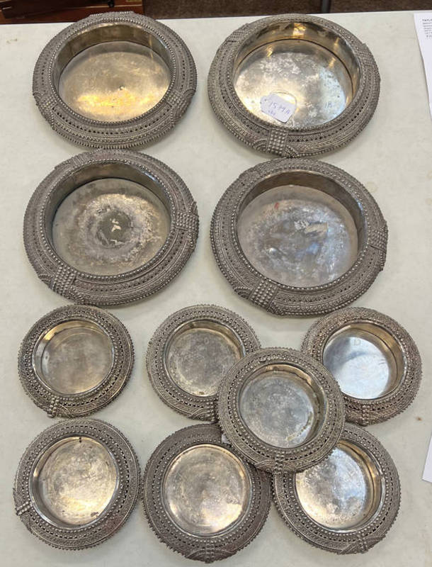 FOUR WHITE METAL MIDDLE EASTERN CIRCULAR TRAYS AT 21.