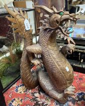 CARVED WOODEN ORIENTAL DRAGON WITH GREEN INSERTS TO EYES,