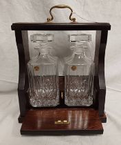 OAK TANTALUS WITH BRASS FIXTURES & 2 CUT GLASS DECANTERS