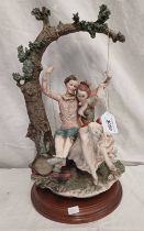 CONTINENTAL CERAMIC FIGURE OF A COUPLE ON TREE SWING,