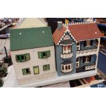 FOUR WOODEN DOLLS HOUSES.