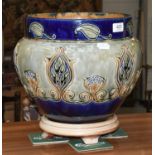 A Royal Doulton Stoneware Jardiniere, tube lined with stylized flowers on a blue and green ground,