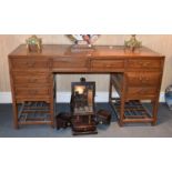 An Early 20th Century Elm Chinese Desk, with an arrangement of eight drawers, raised on square legs,