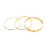 Three Bangles, of varying designs (a.f.)Thickest bangle - cut, tested as 14 carat gold, 29.2
