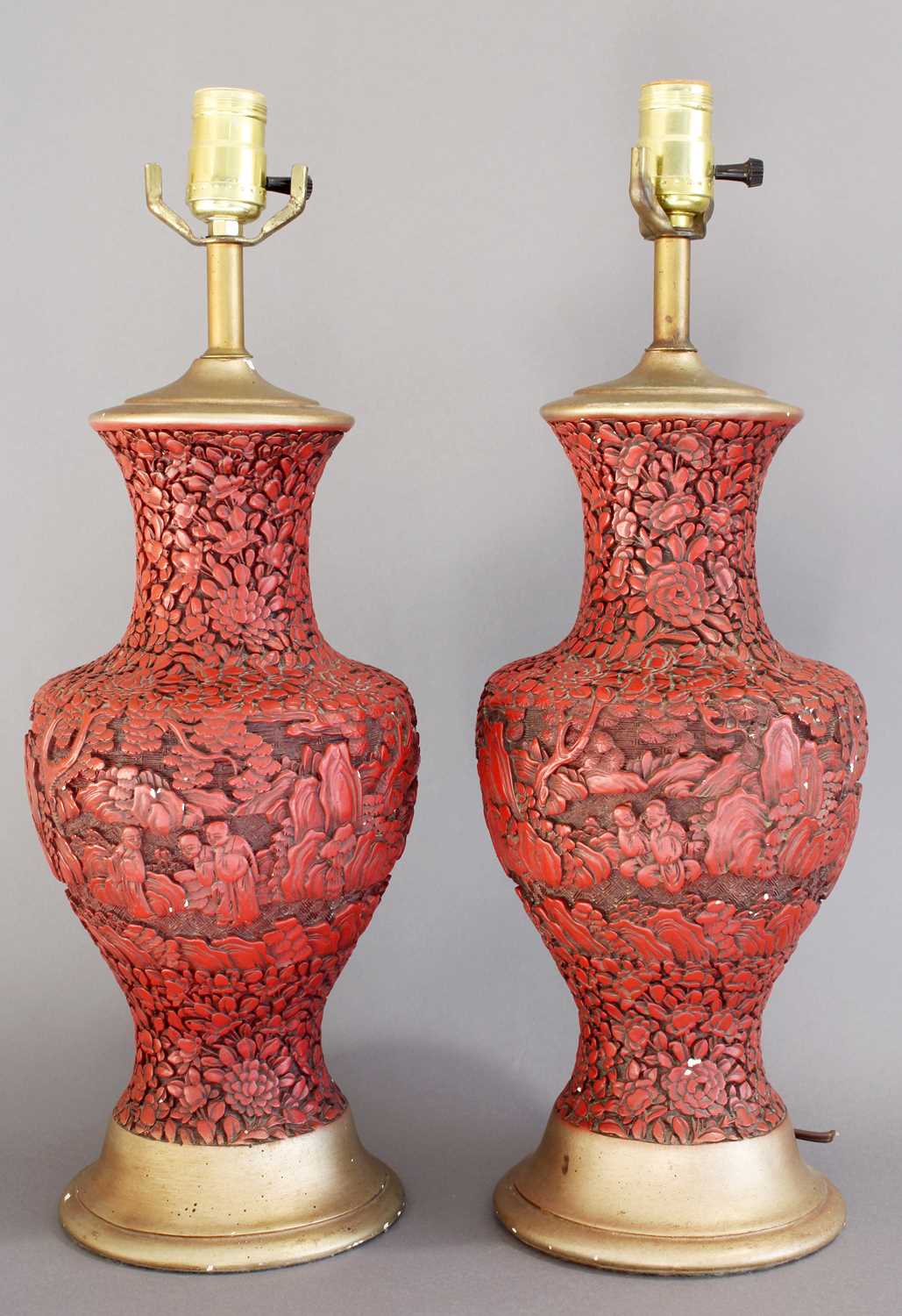 A Pair of Chinese Cinnabar Style Vases, of baluster form, carved with figures amongst foliage,