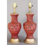 A Pair of Chinese Cinnabar Style Vases, of baluster form, carved with figures amongst foliage,