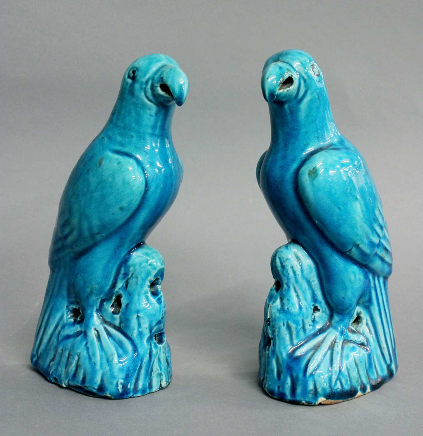 A Pair of Chinese Blue-Glazed Porcelain Parrots, Qing Dynasty, naturalistically modelled perched