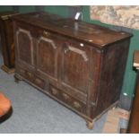 An 18th Century Oak Mule Chest, the rectangular top above three carved and moulded panels, over