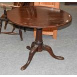 A George II Mahogany Tilt Top Tripod Table, with bird cage platform, downswept legs and pad feet,