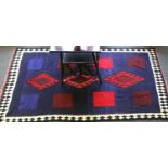 A Kashgai Kilim, the indigio field of three stepped medallions enclosed by crenellated pnaels and