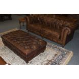 A Buttoned Brown Leather Chesterfield Four Seater Sofa, 214cm by 95cm by 76cm, together with a