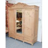 A 20th Century Pine Mirror Fronted Triple Wardrobe, fitted with base drawers, 183cm by 62cm by