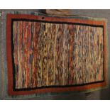 A Modernist Hand Knotted Rug, the polychrome field enclosed by narrow borders, 114cm by 85cm;