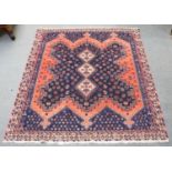 An Afshar Rug, the crenallated indigo field centred by three stepped ivory medallions framed by