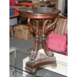 A 19th Century Carved Mahogany Lamp Table, the moulded circular top supported by three swan head
