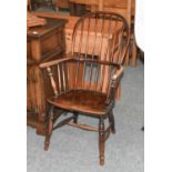 An 19th Century Ash and Elm Windsor ChairFront left leg with a split. Structurally sound. Has a