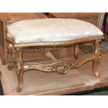 A Louis XV Style Gilt Framed Stool, the shaped padded seat above a framework carved with shells