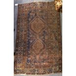 A Baluch Rug, the field with urns issuing flowers enclosed by larch hook vine borders, 187cm by