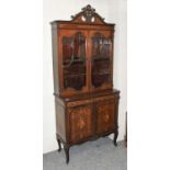 An Edwardian Inlaid Mahogany Bookcase Cabinet, the acanthaus leaf carved swan neck pediment over a
