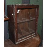 An 18th Century Glazed Bookcase, rope twist carved edging around a single glazed door, opening to