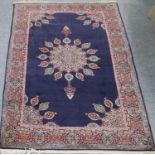 An Indian Carpet of Ardabil Design, the indigo field with flower head medallions and lanterns framed