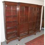 A Mahogany and Ebony Strung Break Front Dwarf Bookcase, with adjustable pine shelves, raised on
