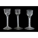 A Wine Glass, circa 1750, the ogee bowl on an opaque twist stem15cm highTwo Similar Glasses15cm