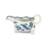 A Bow Porcelain Sauceboat, circa 1755, of silver shape, painted in underglaze blue with the