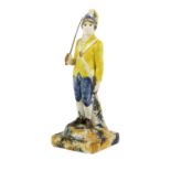 A Prattware Military Figure, circa 1790, as a loyal volunteer, standing holding a sword on a