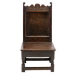 An Early 18th Century Joined Oak Back Stool, the top rail carved as leaves above a plain fielded
