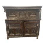 An Early 18th Century Oak Press Cupboard Dated 1701, the canopy top with inverted finials above