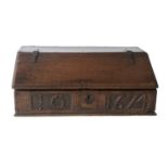 A 17th Century Carved Oak Bible Box, initialled IG and dated 1674, the moulded slope with iron